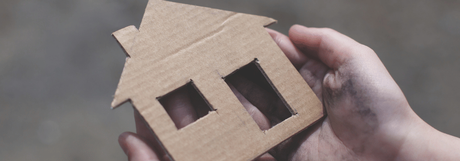 Cardboard cut into shape of a house